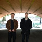 two men standing in a tunnel